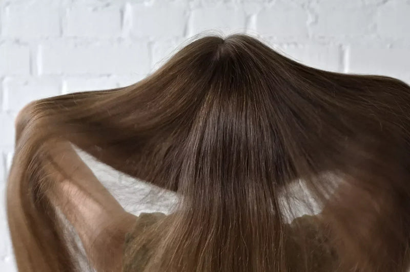 A brunette shows off her very long hair extensions.