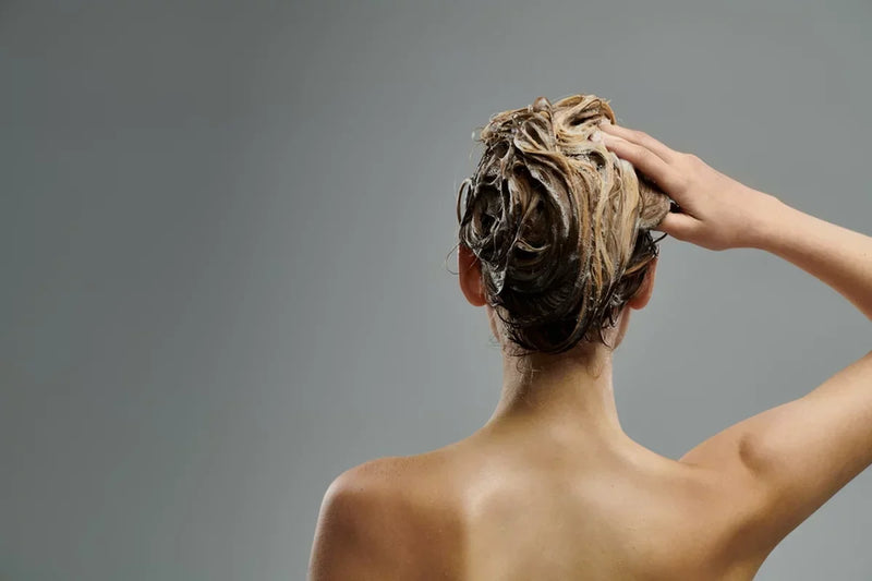A woman follows a volumizing hair care routine