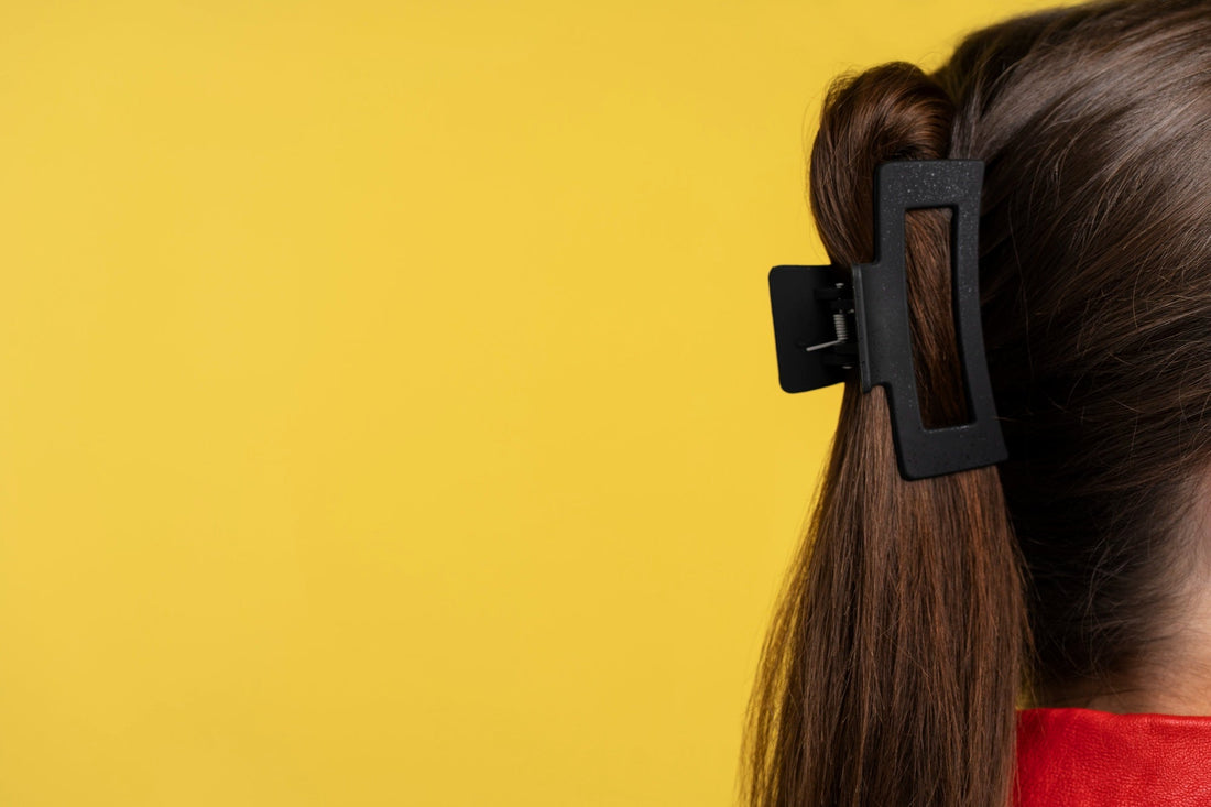 Side profile image of a claw clip holding up extensions.