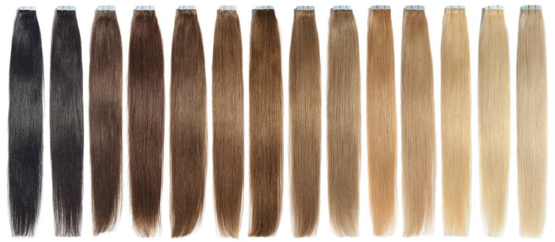 A gradient of colored hair extensions ranging from darkest to lightest