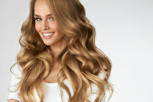 A woman with gorgeous blonde clip in hair extensions smiles for the camera