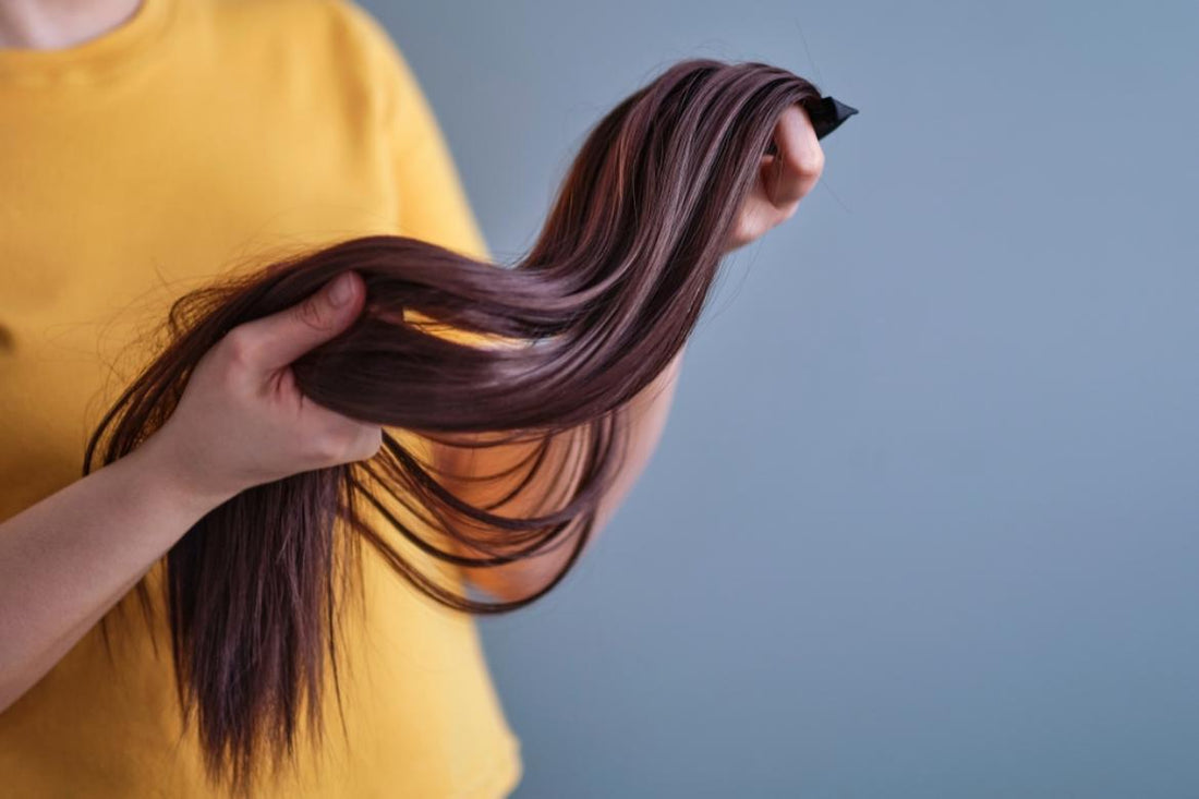 A woman holds a luxury hair extension