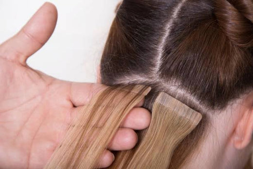 A hand holds a hair extension on a girl. Source: iStock.