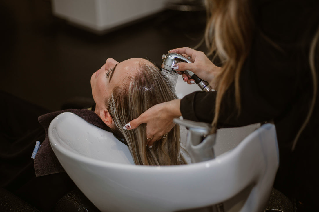 A woman having her hair rinsed in a salon.