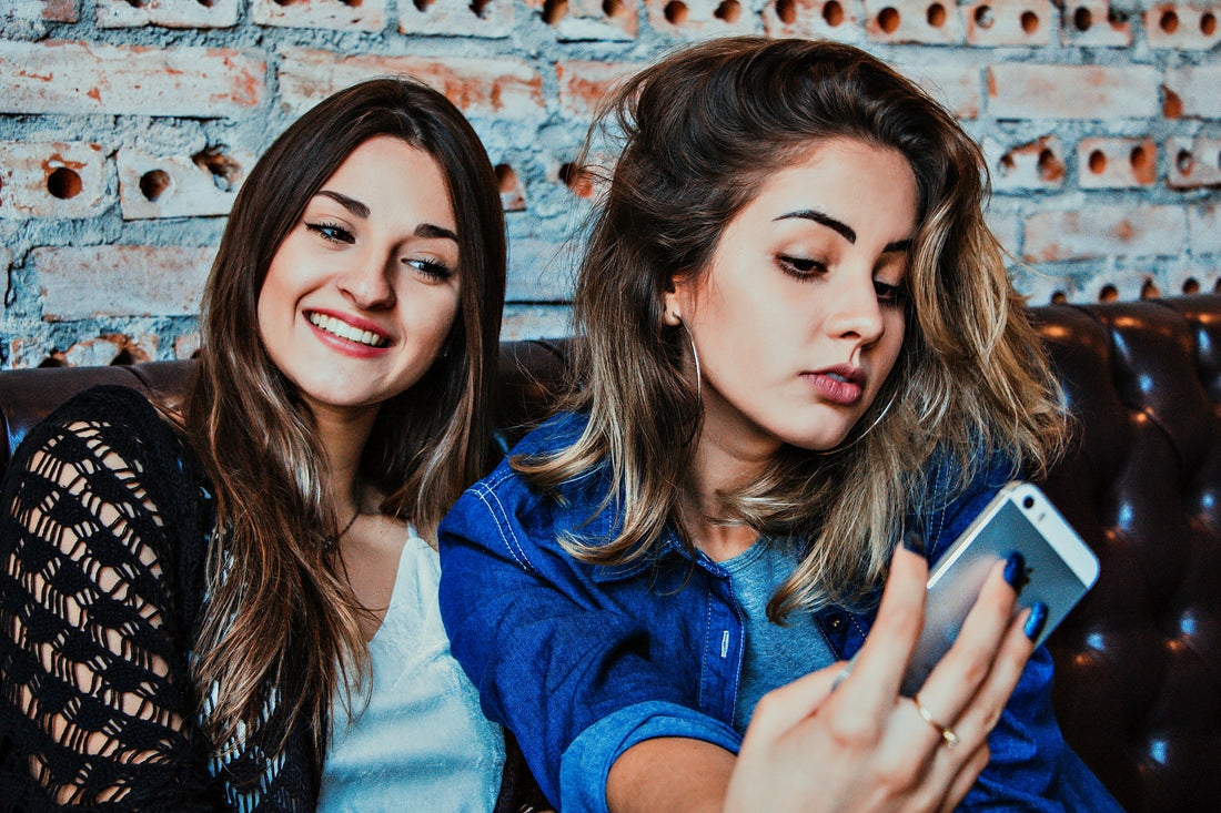 Image of two girls taking an AI selfie