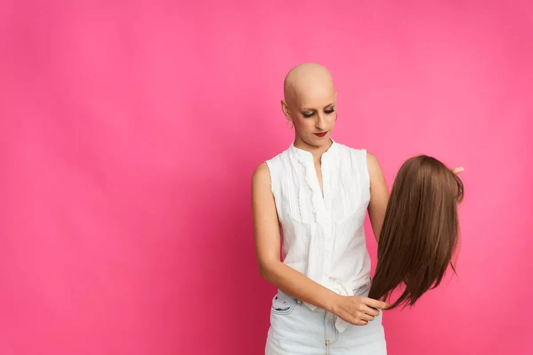 A bald woman with cancer examines her new wig.
