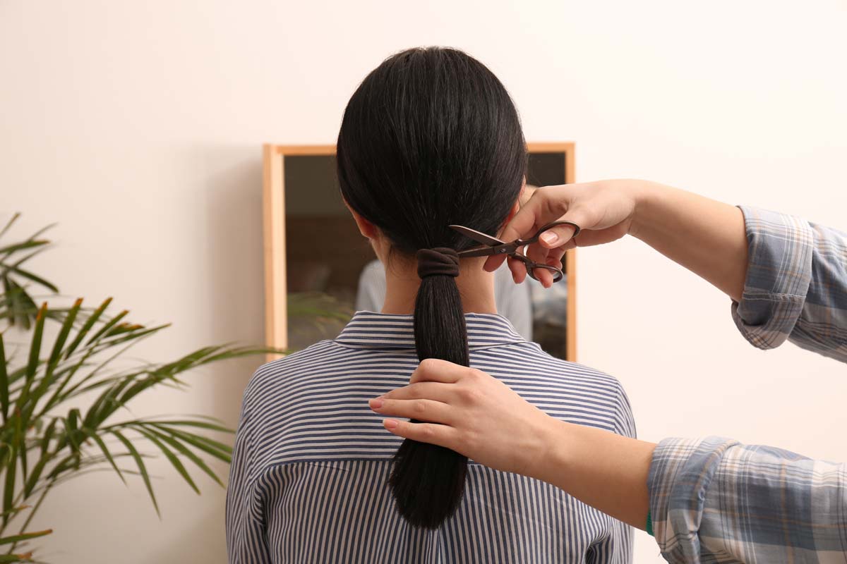 A hairdresser cutting a woman’s hair