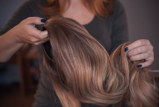 Women holding a brunette wig