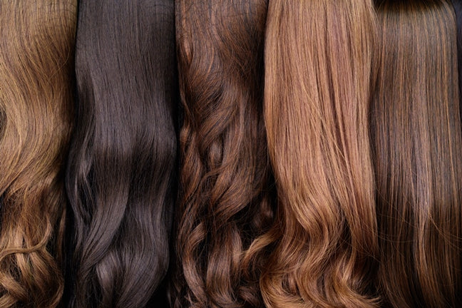 Close up of hair wigs ranging from blonde to brunette