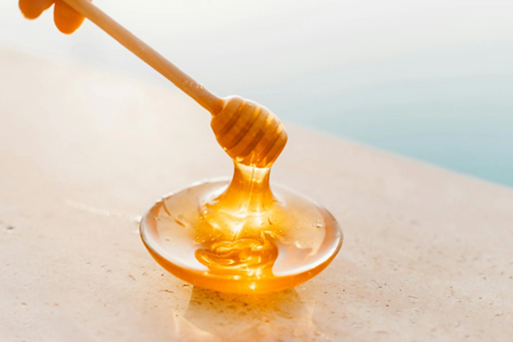 picture of golden honey on a stick.