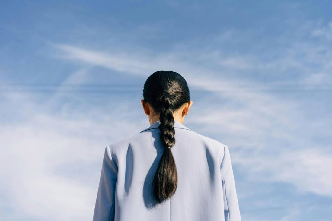 A woman with a super thick, braided ponytail hair extension. Image credit: Pexels, Cottonbro.