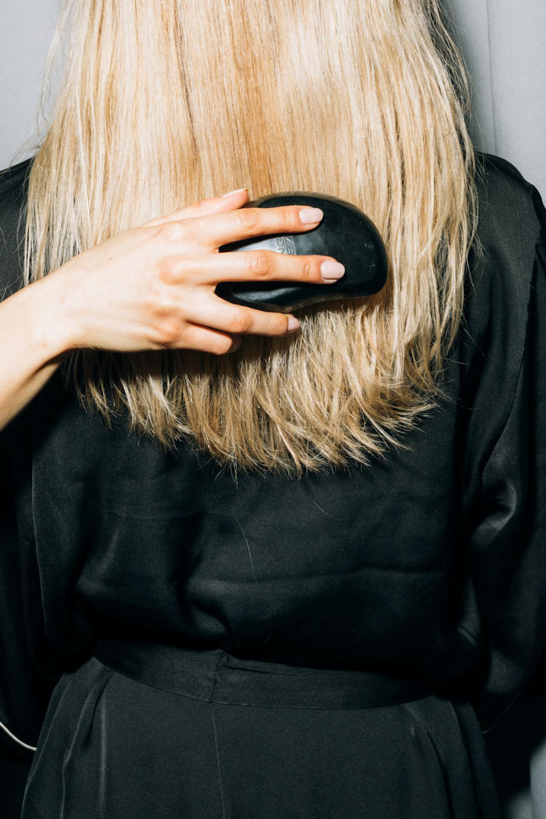 Image of blonde hair getting brushed from behind. Taken from Pexels