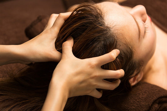 Hands massaging scalp.