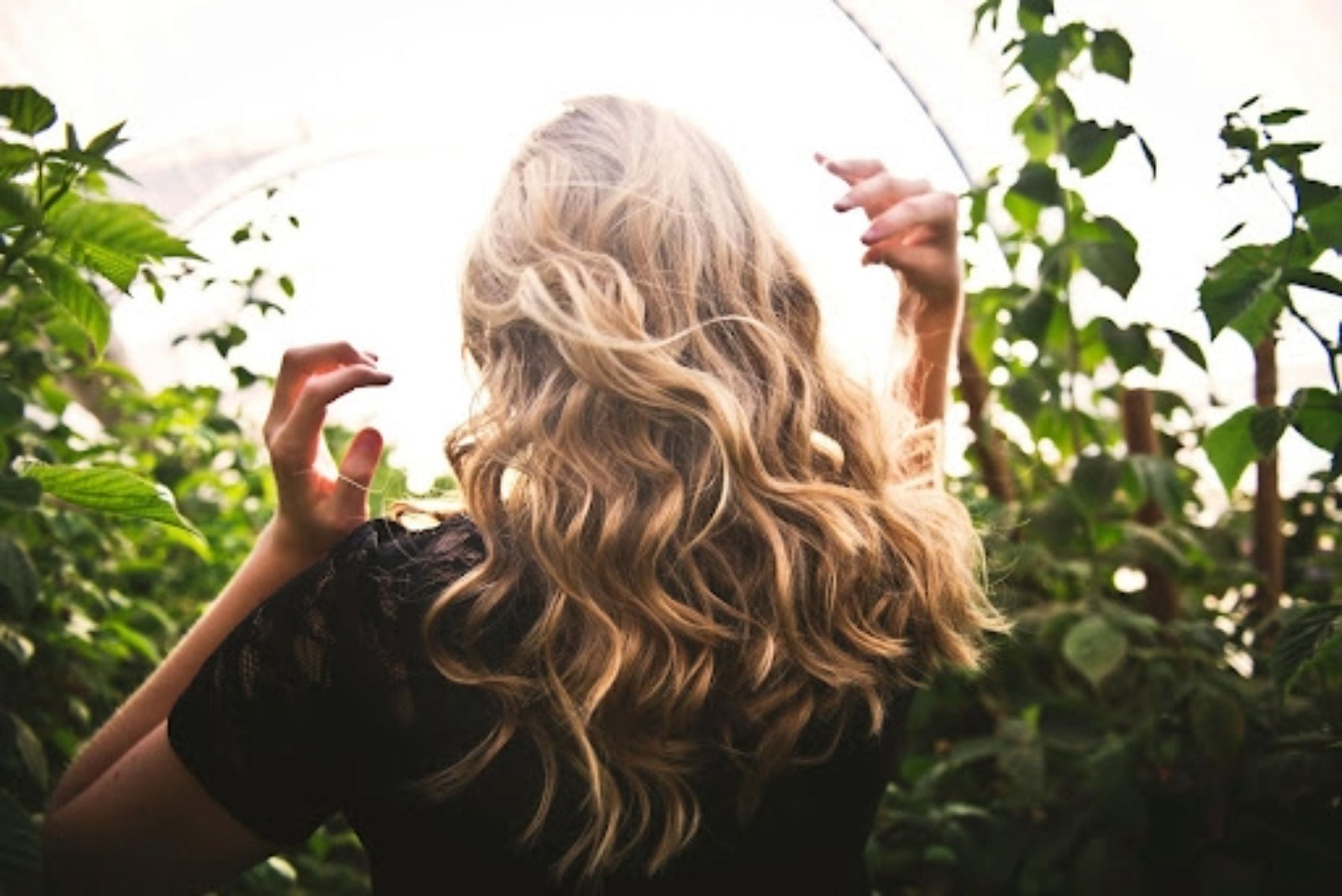 A woman with long, blonde curly hair extensions. Credit: Tim Mossholder, Pexels