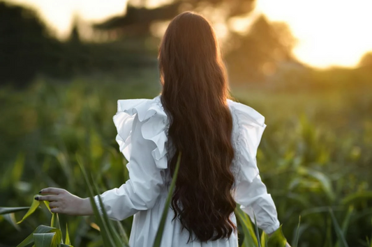 (Image of a girl in a field with long dark hair flowing down her back. Taken from Pexels)