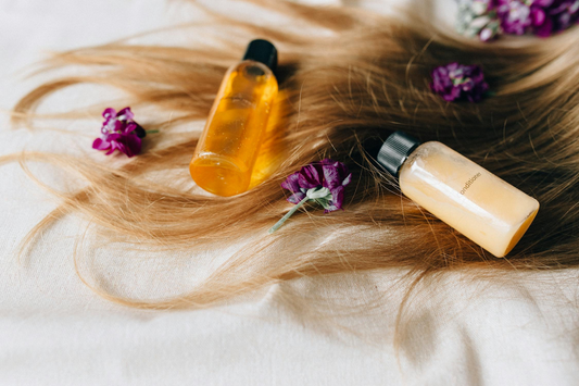 Image of hair on a white surface with products on top.