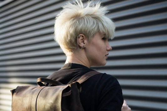 A young woman with short hair looking into the distance Source: Pexels.