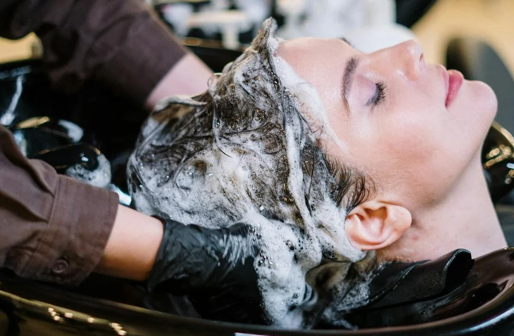 A woman having her hair washed in a salon.