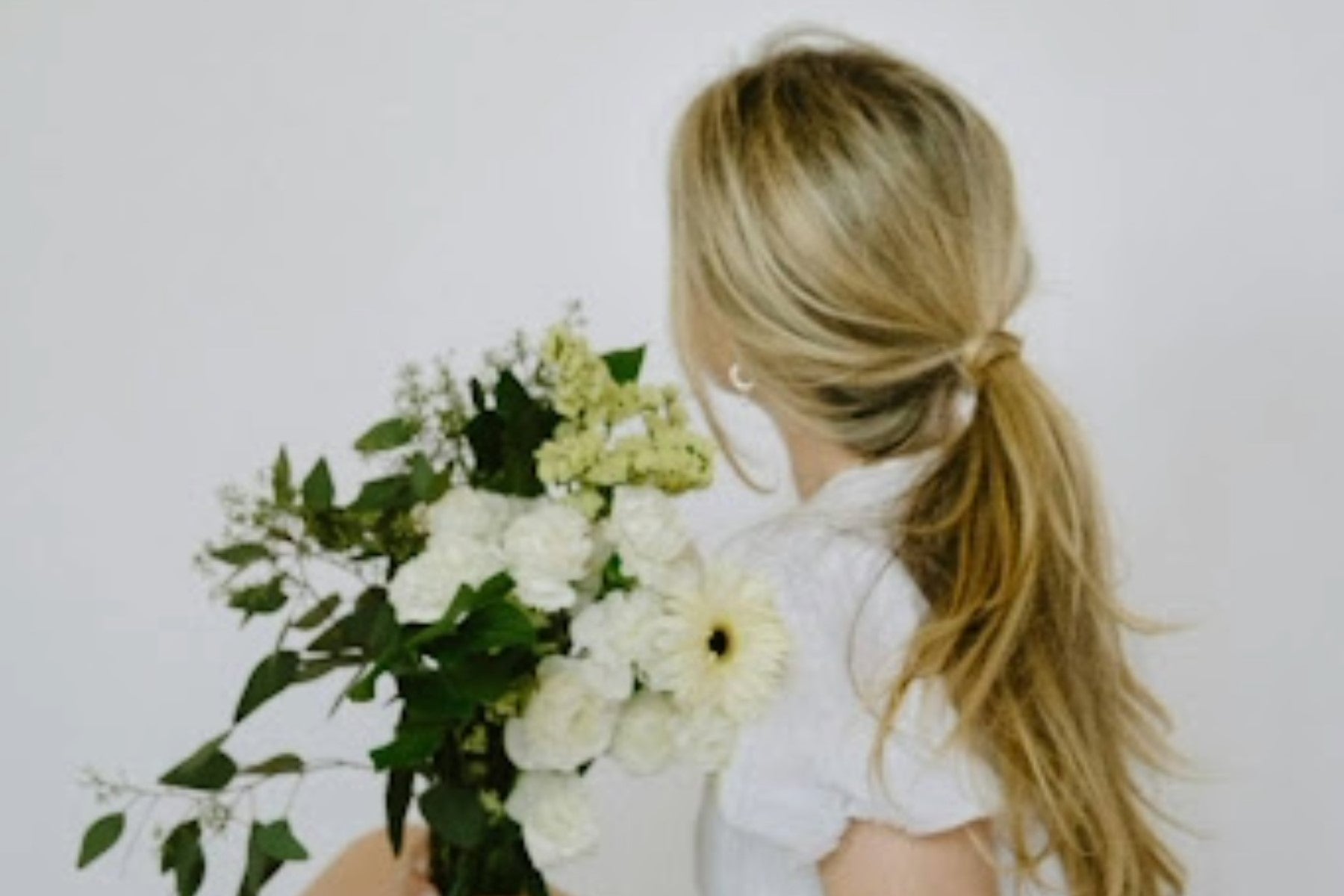 (Image of a girl with long blonde hair extensions. Taken from Pexels)