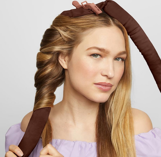 Image of a girl with a silk curling ribbon in their hair.