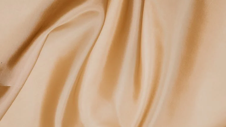 A close-up shot of a wrinkled silk pillowcase.