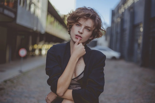 A young woman with a short hairstyle stood in the street.