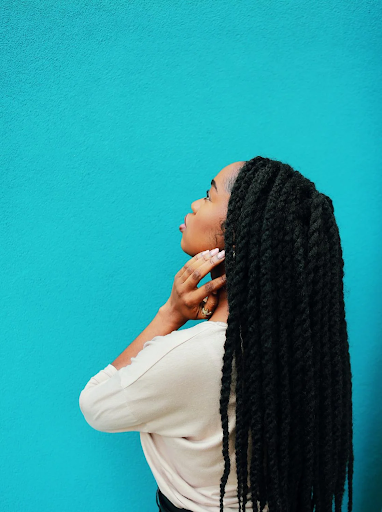Image of a lady from the side showing off her twist hairstyle