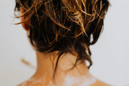 Hair on the back of a woman’s head who is washing her hair. Taken from Pexels