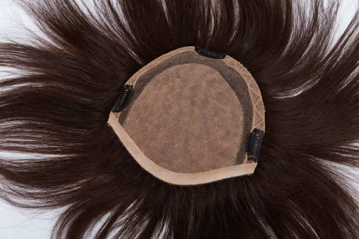 Brunette hair topper laid flat for underside view.