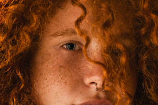 Image of a girl showing her red curly hair.