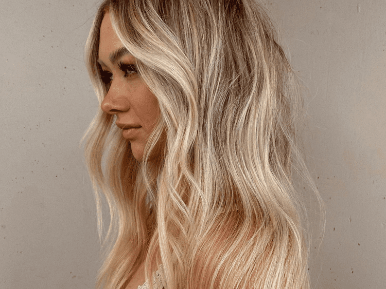 Image of girl with blonde hair to the side.