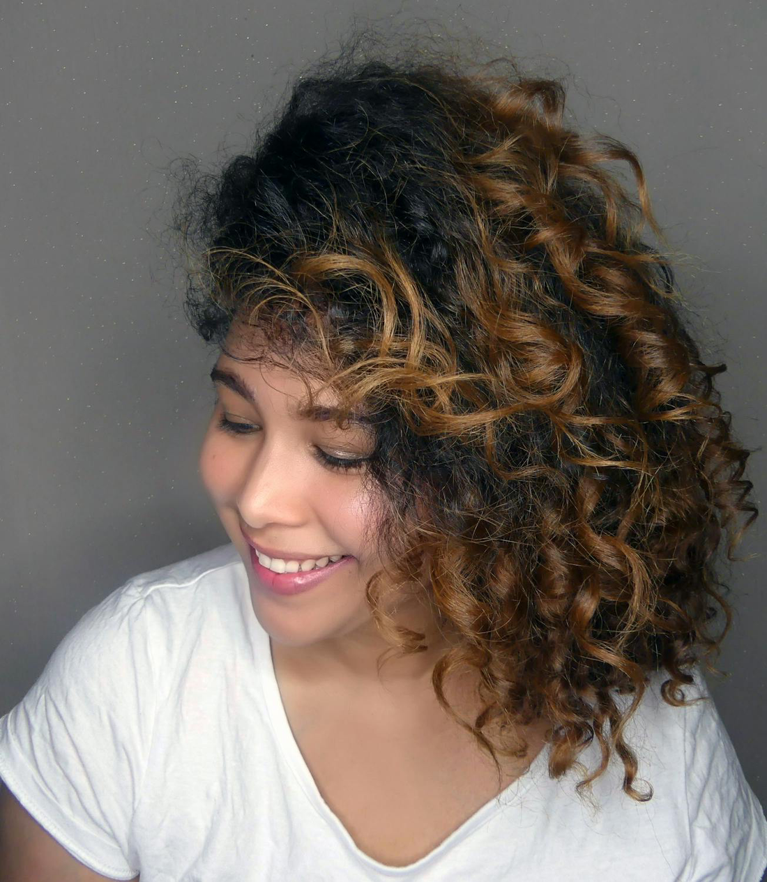 Image of a girl smiling with curly hair