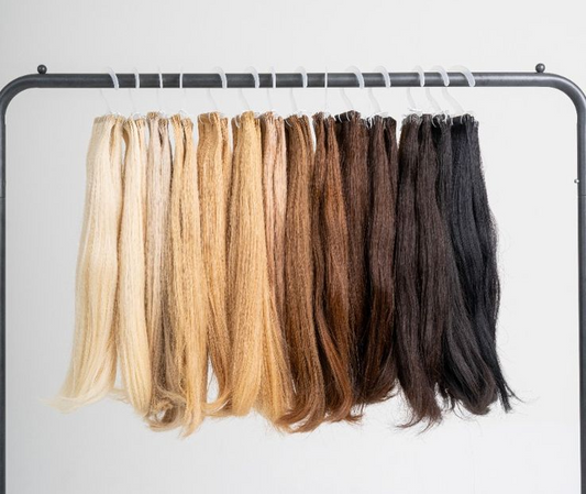 A variety of permanent hair extensions hung on a rack.