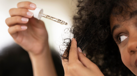 Image of a lady oiling her highly porous hair.