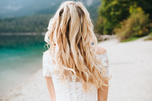 Image of a girl with blonde hair from behind. 