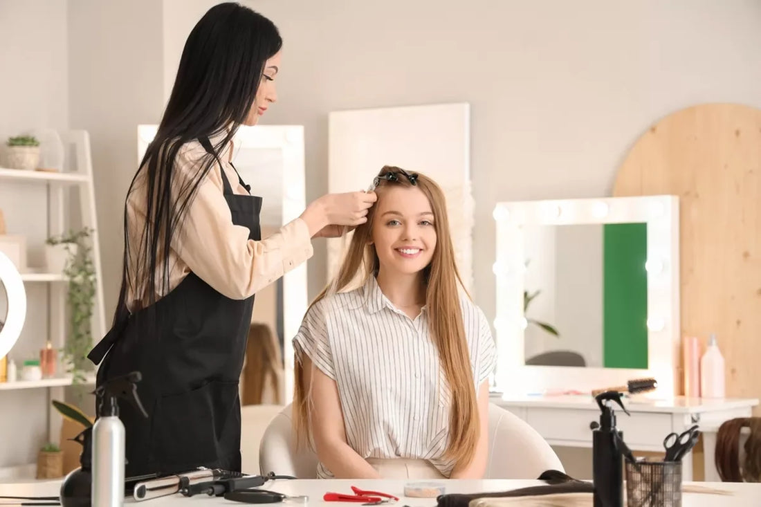A girl at the salon gets long, blonde hair extensions.