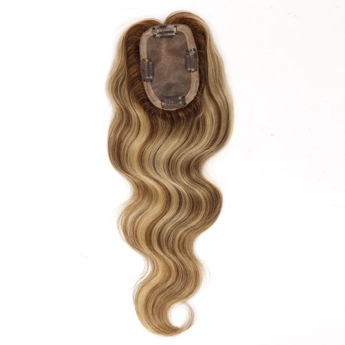 Premium human hair arranged in a salon before being hand-knotted into a hair topper