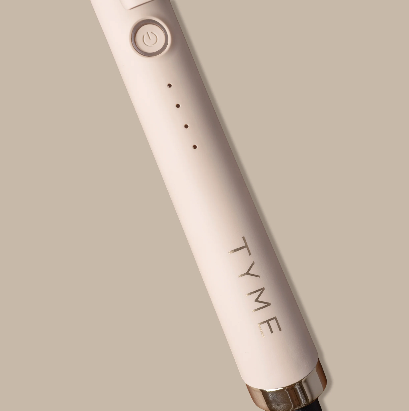 TYME 1.25 inch curling iron shown creating a bouncy curl on long hair