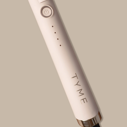 TYME 1.25 inch curling iron shown creating a bouncy curl on long hair