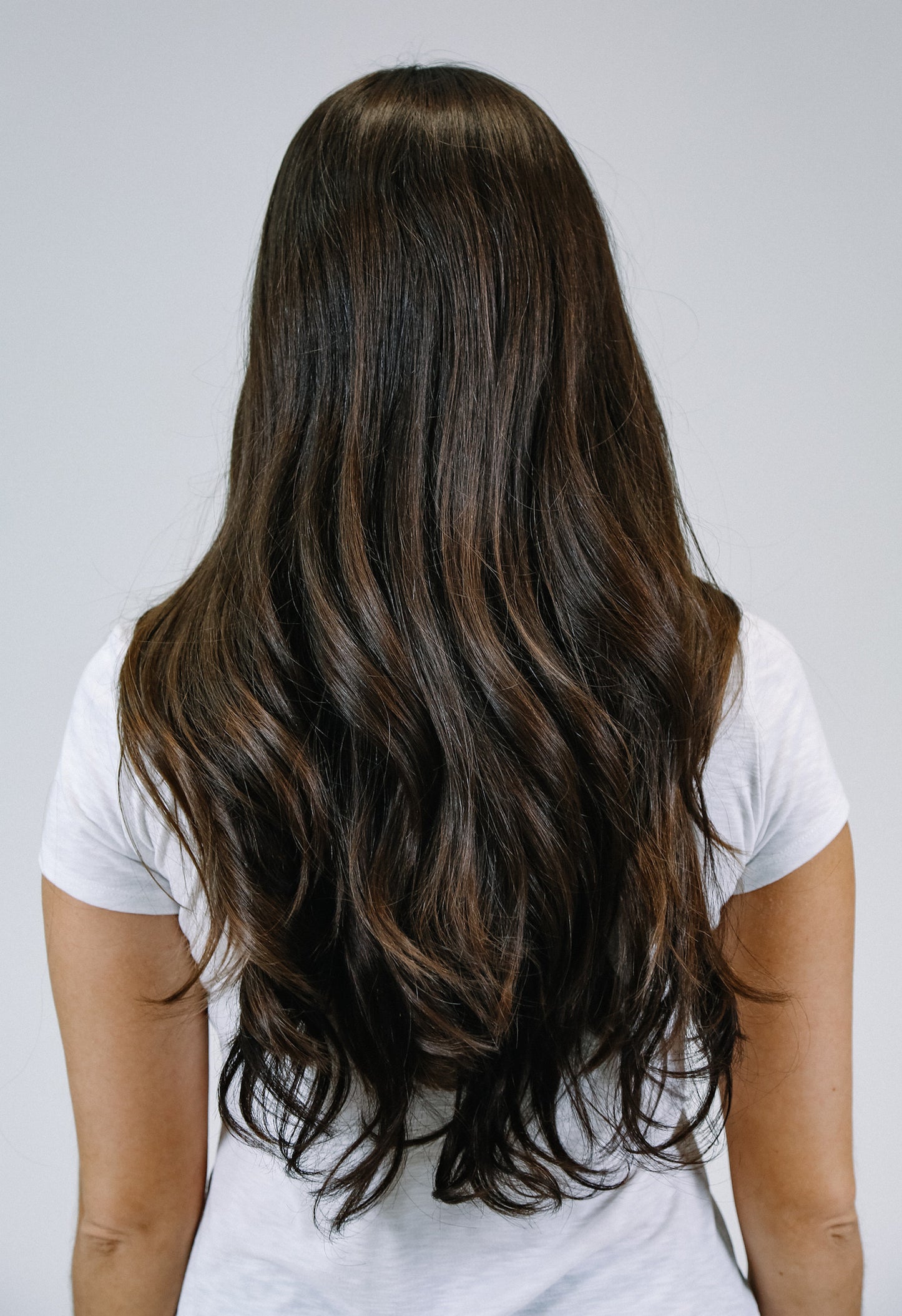 Woman wearing brown hair extensions - back veiw